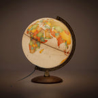 Illuminated world globe lamp on a dark background