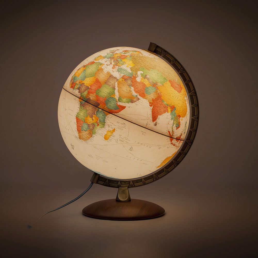 Illuminated world globe lamp on a dark background